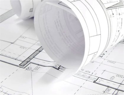 Rolled architectural blueprints and technical drawings symbolizing real estate planning, documentation, and data-driven valuation processes in the Berlin Hyp project.