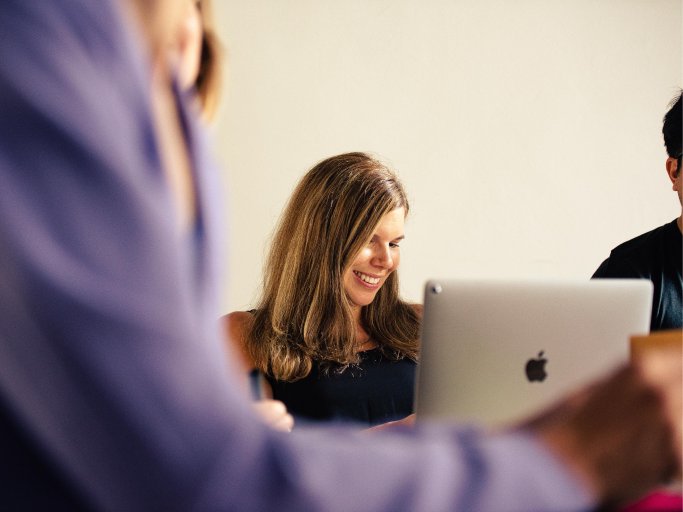 Woman sitting in front of laptop during client requirement workshop